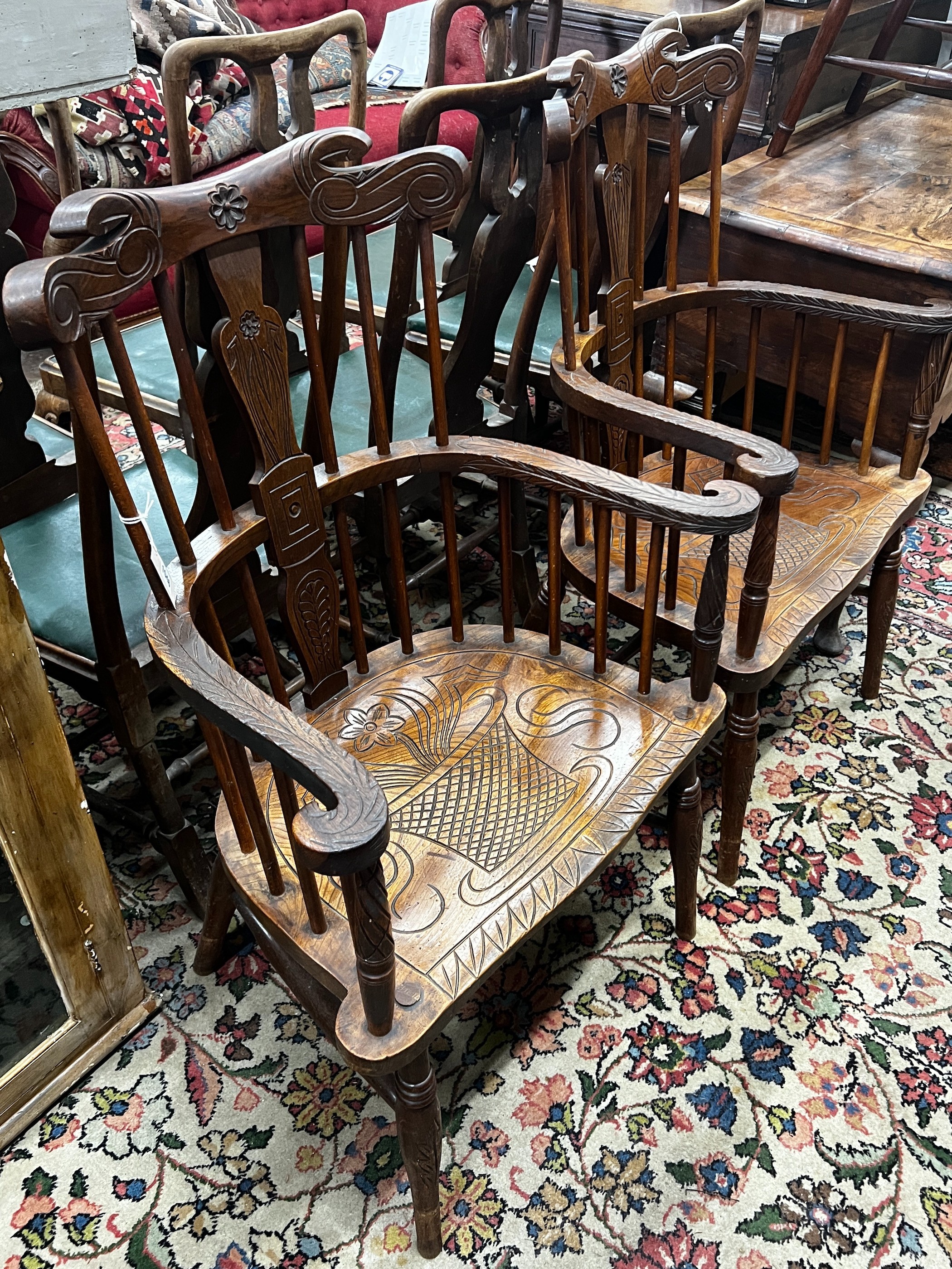 A pair of carved elm Windsor armchairs, width 69cm, depth 45cm, height 107cm